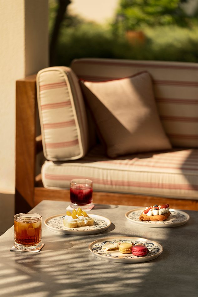 Afternoon pastries and cold drinks on a terrace table